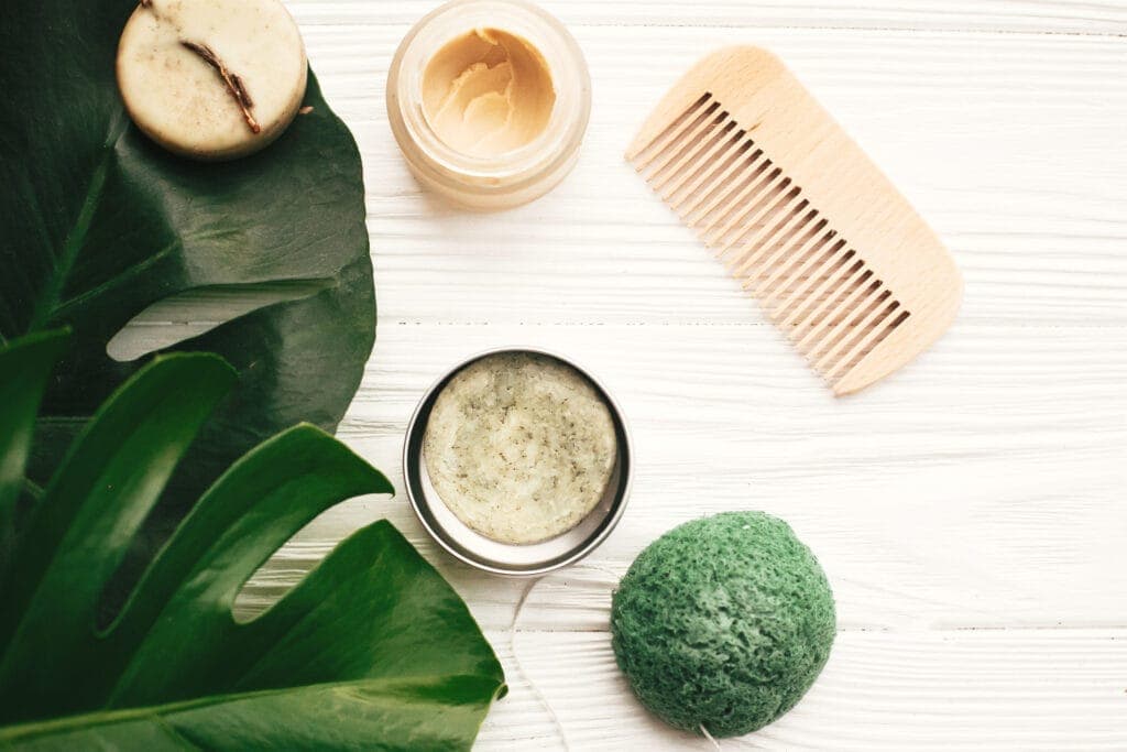 Hair care bottles and natural oils on a light background