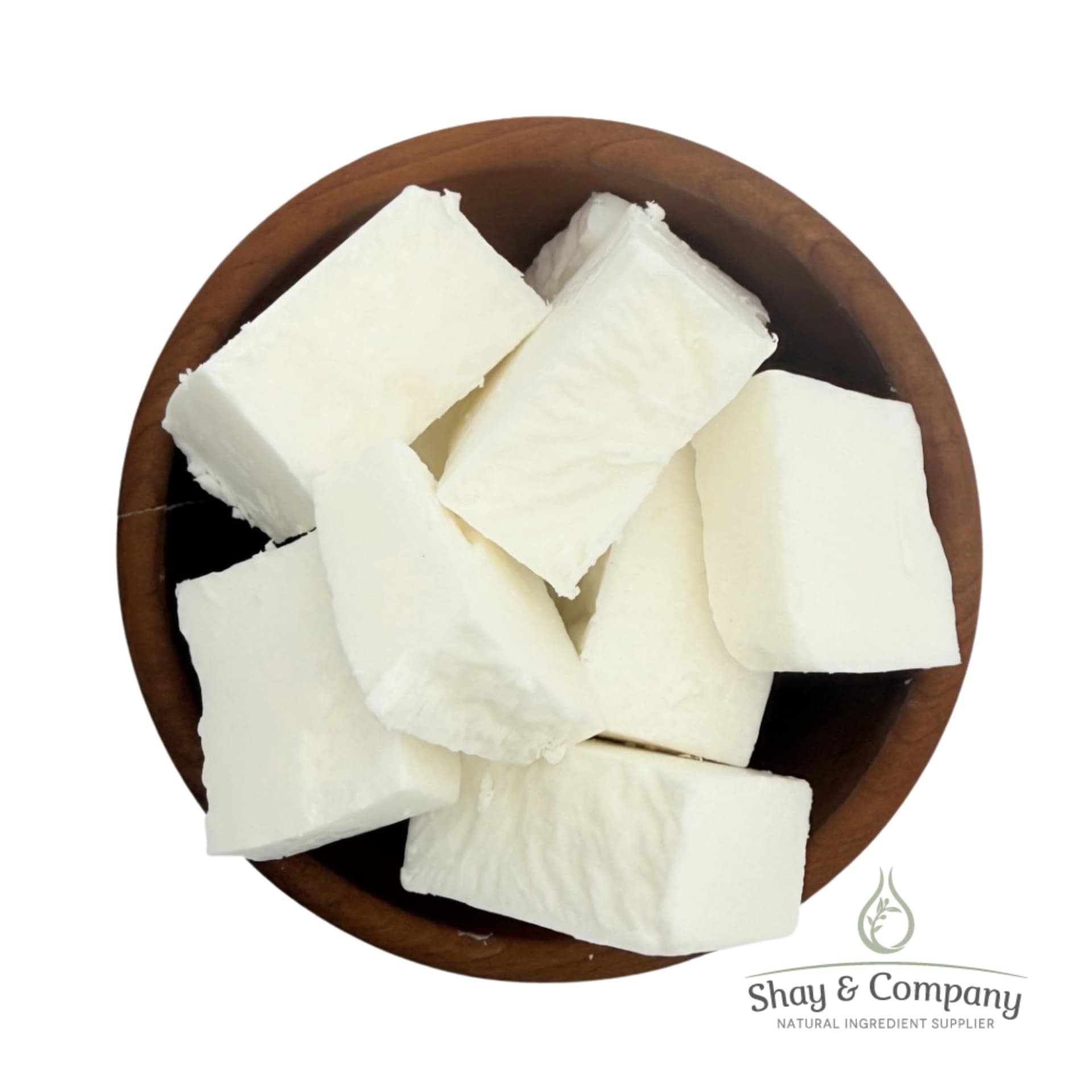 Creamy white shea butter chunks in a wooden bowl from Shay and Company.