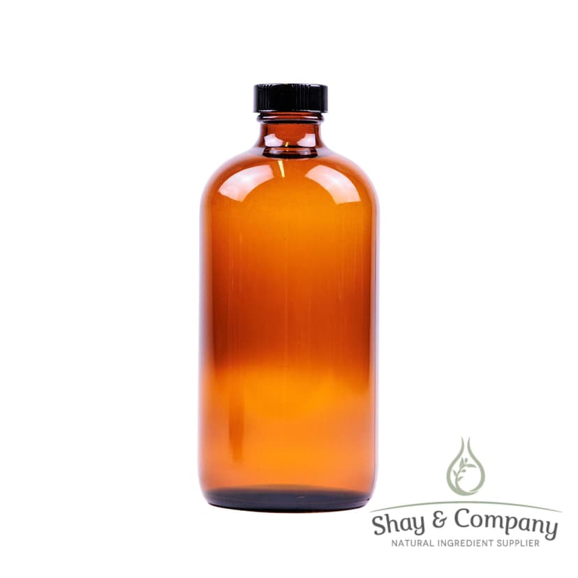 Amber glass bottle with black cap from Shay & Company natural ingredient supplier on white background.