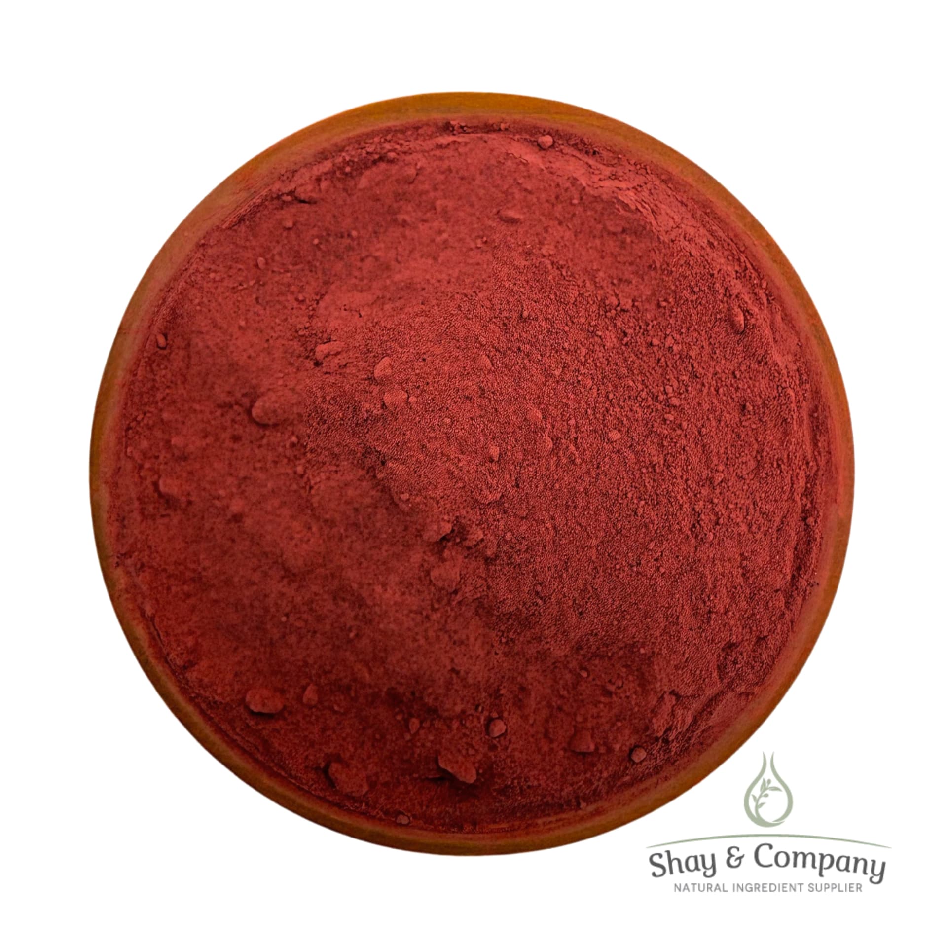 Red powder pigment in wooden bowl from Shay & Company natural ingredient supplier.