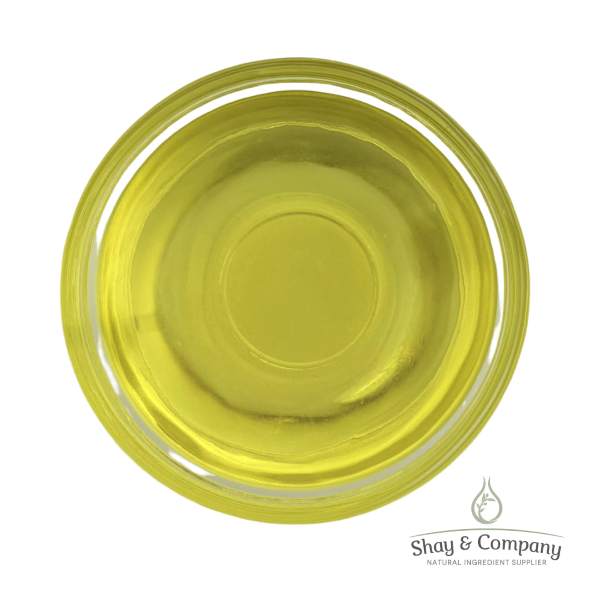 Top-down view of yellow carrier oil in a clear glass dish with Shay & Company logo.