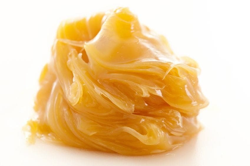Golden bird's nest noodles stacked in a crispy, curled bundle on white background.